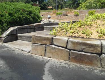 Retaining wall. A hand carved, stamped and stained concrete retaining wall.