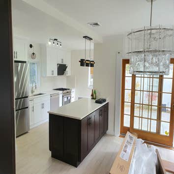 Kitchen Remodel Reconfigured space with new hardwood shaker cabinets with Quartz countertops.