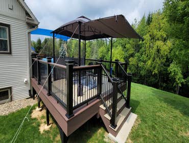 Photos by Trinity Custom Home Builders LLC #5 custom 16x32 Timber Tech deck with lights
