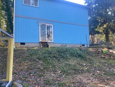 Hillside Deck Project Added a new deck on the back side of home, with steep slope. Customer wanted composite decking without a railing.