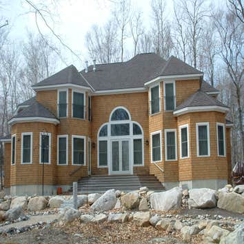 Amato Project 5200 sq ft Colonial on Big Sebago Lake. Rounded staircase and balcony, custom designed kitchen, 30' cathedral ceilings. The interior has 