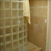 NW Penridge This beautiful spa-like contemporary bathroom features Italian limestone tile, including very unusual 18" x 18" floor tiles and mosaic deta