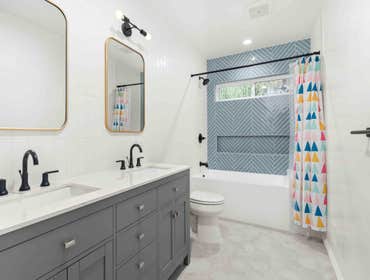 Photos by Bela Development #8 Two Bathroom Remodels
