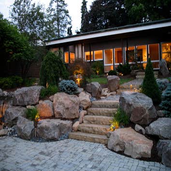 asian design in a social setting client requested an asian setting in the front yard incorporating water, walkways, driveway and full plantings.