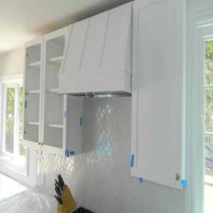 Studio City kitchen Installed white kitchen with marble counter tops center island with custom overhang. Custom built overhead stove fan. Farm...