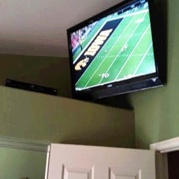 45 inch TV mounted over bedroom door