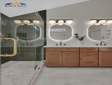 Mountain View, 3 Bathrooms A modern bathroom remodel featuring a custom walk-in shower with green vertical tile, frameless glass enclosure, and brushed