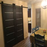 Kitchen Remove wall between kitchen and office to create open floor plan. Add new cabinets, flooring, appliances and lighting.