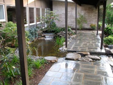 asian design in a social setting client requested an asian setting in the front yard incorporating water, walkways, driveway and full plantings.