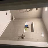 Photos by Battles Home Improvement Co Inc #1 Custom walk in shower complete with bench seat, recessed shampoo shelf, foot rest, safety bars and a hand