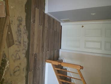 Photos by Exquisitely Renovated, LLC #2 Removal of existing carpet. Install new porcelain tile, grout and seal grout. Install new show molding throug