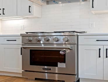 Close up of the stainless prostyle range and subway tile backsplash in the kitchen at 1135 Delmas Ave, East Nashville by CJMC Build.