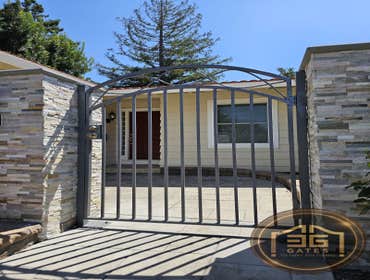 Custom Steel Pedestrian Gate & Stone Entry Columns | Santa Clara, California This project features a custom steel pedestrian gate paired with premium s