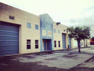 repainting warehouse in Hialeah Pressure washed, one coat of primer two coats of paint