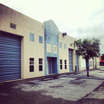 repainting warehouse in Hialeah Pressure washed, one coat of primer two coats of paint
