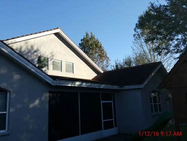 Photos from Popa Construction LLC Before & Afters of a soft wash roof cleaning and driveway and side walk cleaning.