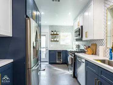 Van Nuys Kitchen & Bath Remodel We transformed this Van Nuys home with a modern kitchen and bathroom! The kitchen boasts navy cabinets with brass handl
