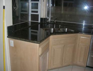 Kitchen Remodeling in H.B. Ca We replaced the Kitchen tiles , also put new granite counter tops and bathroom counter tops.