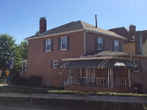 Covered back deck and side porch This beautiful backyard oasis includes a spacious deck which is partially covered by a 12 foot cathedral roof. This 