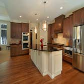 Lockridge Residence This new Transitional Custom Home was built on the owners heavily wooded lot and designed to maintain the woodsy feel while taking 