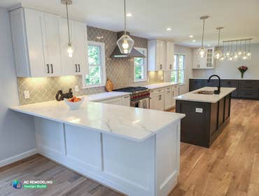 Massive Kitchen Redesign This huge kitchen remodel includes both a peninsula and an island. The shaker style cabinets in white and gray complement well