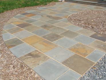 Walkways Curved walkway laid in bluestone.