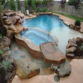 Doyle Custom Pool and Spa Design, Houston Area Doyle Project: A 25 ton moss rock waterfall provides a dramatic backdrop for this natural beauty. Seve