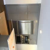 Kitchen (Huntington) A newly updated kitchen with sleek stainless steel applicances. Maple cabinets painted gray with a crown modeling finish, above a