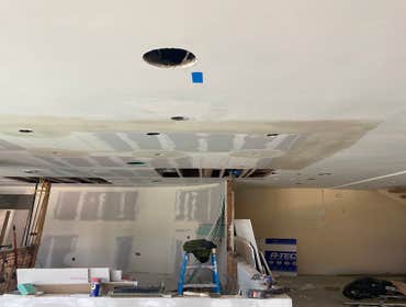 Photos by Interior Art Drywall Inc #1 Hang the walls on ceiling and walls . I just let the open on ceiling where plumbers were pending to fix the pipes
