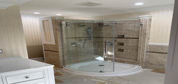 Custom Shower - marble tiling, chrome finish, curved glass