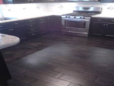 Kitchen Wood plank tile floor and counter backsplash