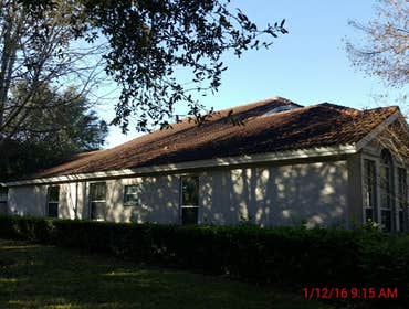 Photos from Popa Construction LLC Before & Afters of a soft wash roof cleaning and driveway and side walk cleaning.