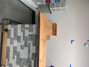 Photos by Olhausen Construction and Management, LLC #5 Custom Bar with Lite Stone walls, epoxy too, and steel black pipe foot rest.