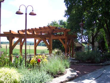 (2) Custom designed timber-framed pergola, timber-framed carport Each timber is hand carved to fit into the joining beam.