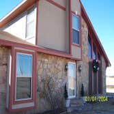 R.U stucco Sandlewood Beige finish on Quarzputz texture and custom mixed Red for the trim.