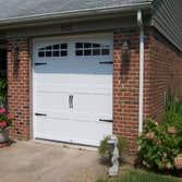 Carriage style doors First door (white with black hardware) is a stamped steel entry level door, second white painted custom door from Carriage House D
