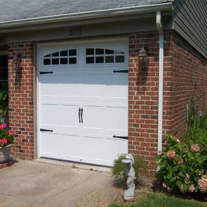 Carriage style doors First door (white with black hardware) is a stamped steel entry level door, second white painted custom door from Carriage...