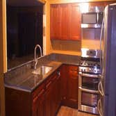 Music Modern Design Projects Porch and granite kitchen tops with a bar.