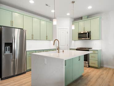 Pamela | Kitchen This kitchen remodel features sage green shaker cabinets, white quartz countertops, and gold hardware for a modern farmhouse feel. A s