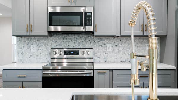 Multicolored tile backsplash and new cabinets
