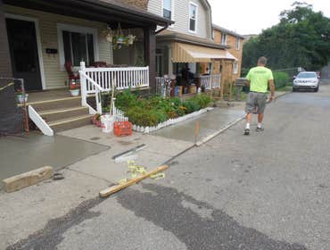 Project photos from Hollis Contracting Tore out the original concrete side walk and removed the stepping stones and pebbles on the pad.
Then we poured 