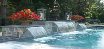 retaining wall with water feature and flower planters