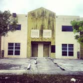 repainting warehouse in Hialeah Pressure washed, one coat of primer two coats of paint