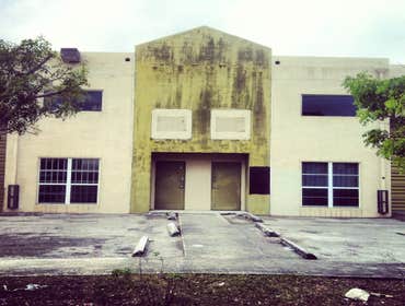 repainting warehouse in Hialeah Pressure washed, one coat of primer two coats of paint