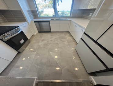 Modern kitchen remodeling project in Los Angeles Modern kitchen remodeling project in Los Angeles featuring sleek white cabinetry, quartz-style counter
