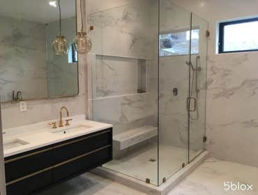 Bathroom Remodel In Los Angeles, CA Master bathroom in Los Angeles created from marble pieces and elements of bronze hardware that come together to for
