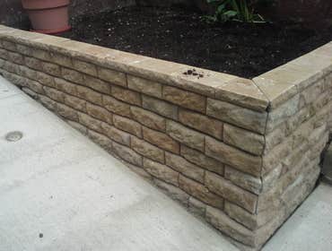 Stone Wall Repair this is what happens when you hire a cheap contractor that doesn't know whats going on. No footer in the dirt caused this wall to mo
