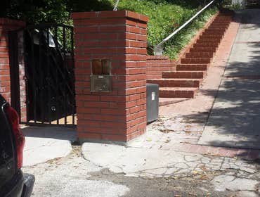 Photos by Ayax Mason Company #3 3"x3"x10" red brick installed for a two sided mailbox.