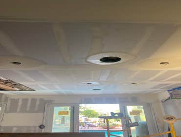 Photos by Interior Art Drywall Inc #1 Hang the walls on ceiling and walls . I just let the open on ceiling where plumbers were pending to fix the pipes