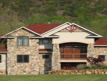 Custom Home In Edinburg VA This home was built with craftsman details. From the deep overhangs on the roof to the tapered stone columns, this house has